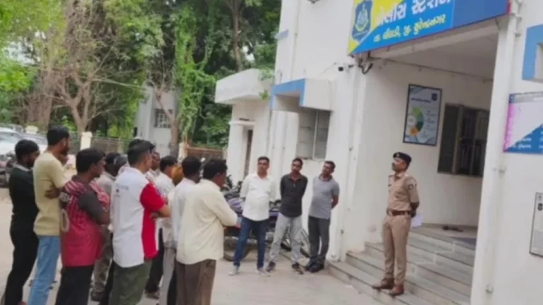 Limbdi police warning bootleggers at police station