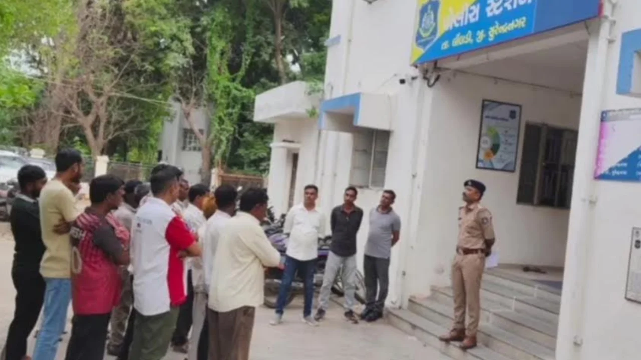 Limbdi police warning bootleggers at police station